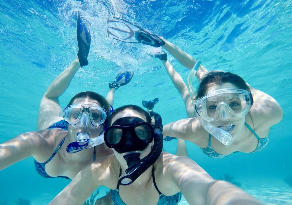 Snorkelers exploring the vibrant coral reef near Alligator Lighthouse in Islamorada, Florida Keys