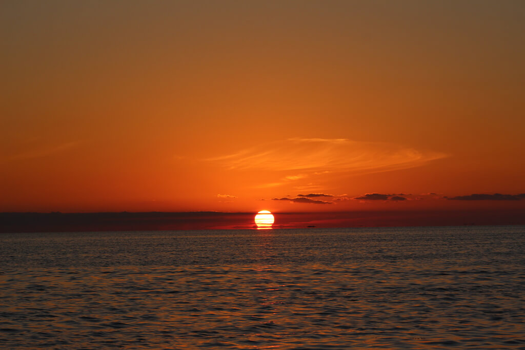 Sunset cruise in Islamorada with vibrant sky and calm water reflecting the colors